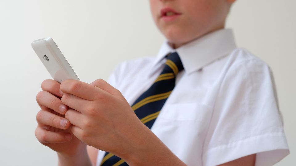 Ministers confirm plan to ban use of mobile phones in schools in England